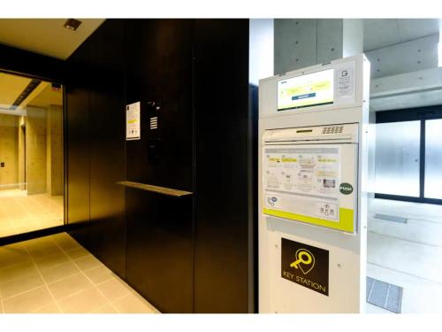 a vending machine in a room with a black wall at ZOOM Esaka Park - Vacation STAY 17114 in Suita