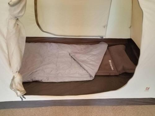 a small bed in the back of a caravan at Ikkodaira Campsite - Vacation STAY 23092v in Daisen
