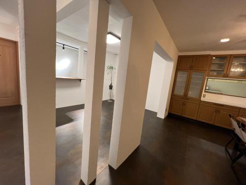 a living room with wooden cabinets and a kitchen at casa hotel - Vacation STAY 17133 in Wakkanai