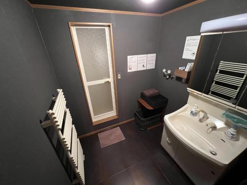 a bathroom with a sink and a toilet and a window at casa hotel - Vacation STAY 17134 in Wakkanai