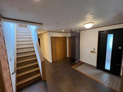 a hallway with a staircase and a stair case at casa hotel - Vacation STAY 17134 in Wakkanai