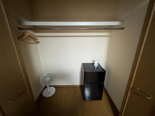 a small room with a small refrigerator and a fan at casa hotel - Vacation STAY 17134 in Wakkanai
