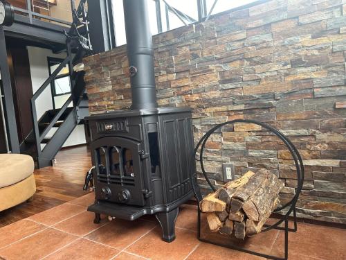 a black stove in front of a stone wall at EIGHT LIFE GO - Vacation STAY 17131 in Zushi
