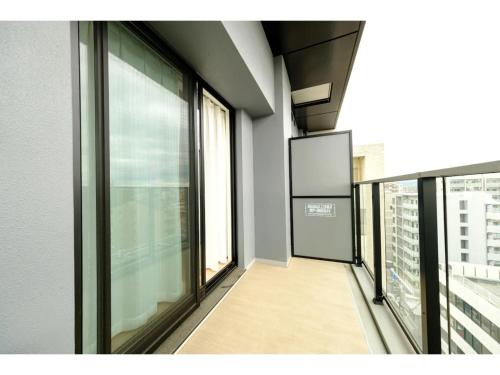 an empty room with glass windows in a building at ZOOM Esaka Park - Vacation STAY 17111 in Suita