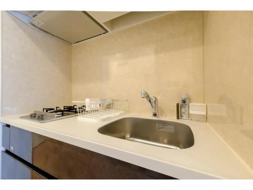 a kitchen counter with a sink and a stove at ZOOM Esaka Park - Vacation STAY 17111 in Suita