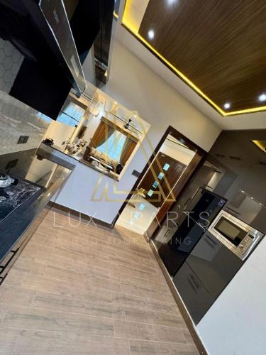a kitchen with a sink and a counter top at Lux Aparts Holiday Home Citi Housing Jhelum in Jhelum