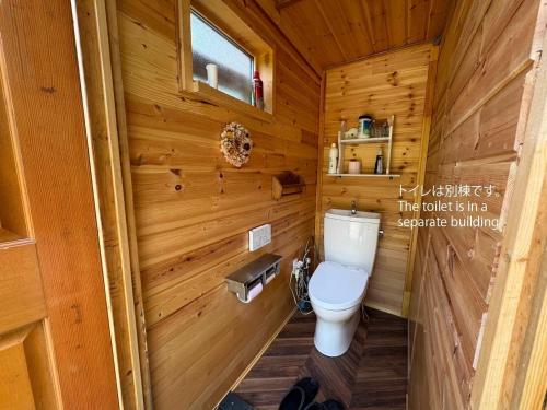a bathroom with a toilet in a wooden cabin at Playhouse Conifer - Vacation STAY 24024v in Mikage