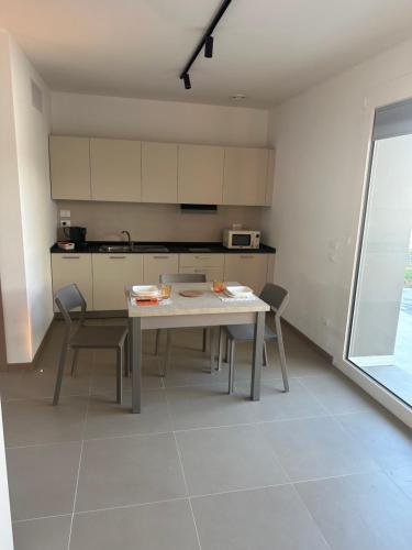 a kitchen with a table and chairs in a room at SELICE 42 RESIDENCE Imola in Imola