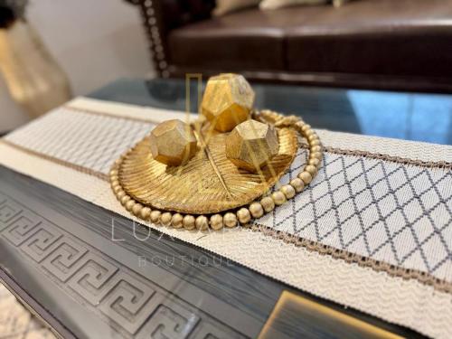 a straw hat sitting on a glass table at Lux Aparts Holiday Home Citi Housing Jhelum in Jhelum