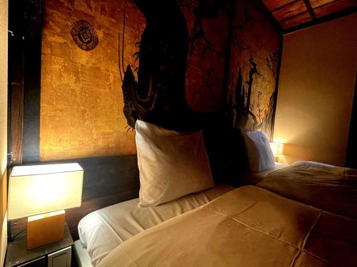 a bedroom with a bed with a headboard and a lamp at Machiya Villa Gashu - Vacation STAY 17142 in Nagoya