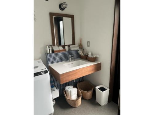 a bathroom with a sink and a mirror at Ryokan YaDOKARI - Vacation STAY 28940v in Toyooka