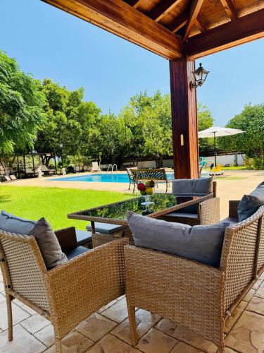 a patio with chairs and a table and a pool at Villa Christina in Protaras