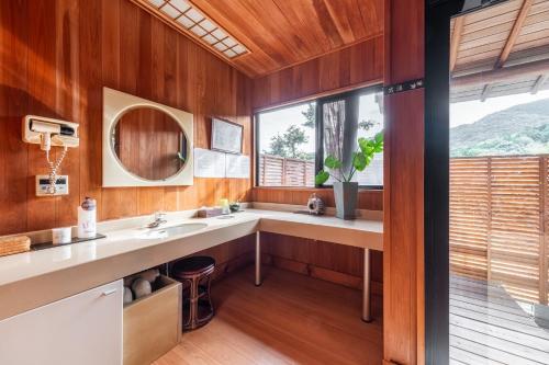 a bathroom with a sink and a large window at Momijisanso - Vacation STAY 36390v in Izu