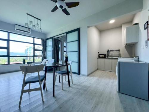 a kitchen and dining room with a table and a ceiling fan at Jesselton Quay BORNEO HAVEN 亚庇好窩 in Kota Kinabalu