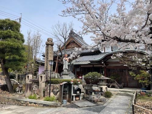 a shrine with a statue in front of a building at Sakura Apartment - Vacation STAY 17178 in Toyonaka