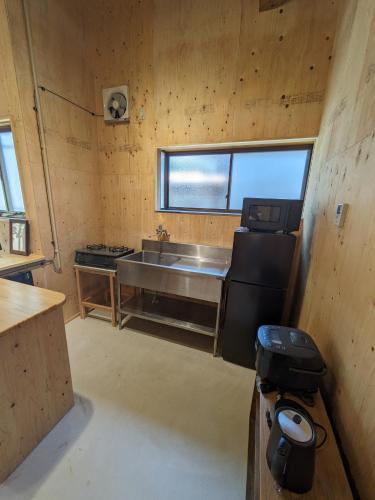 a kitchen with a sink and a stove in a room at HANARE STAY&SPACE - Vacation STAY 38426v in Misaki
