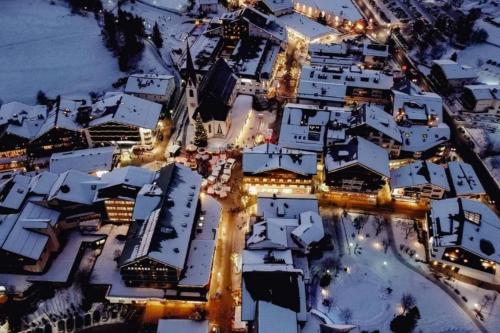 an aerial view of a snow covered city at night at Haus Lundsör-Barret by MoniCare in Seefeld in Tirol