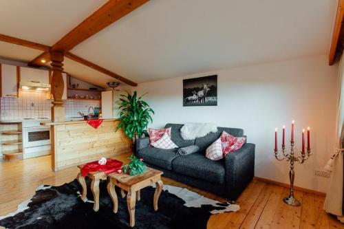 a living room with a couch and a table at Appartement RUDI by MoniCare in Reith bei Seefeld
