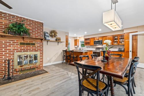 a living room with a fireplace and a table and chairs at New!! Pool Vibes At Vanishing Run in Harwood