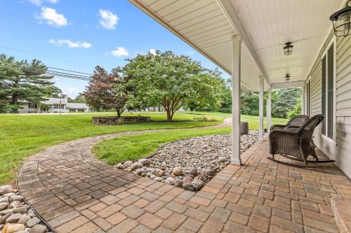 a patio with two chairs on a house at New!! Pool Vibes At Vanishing Run in Harwood