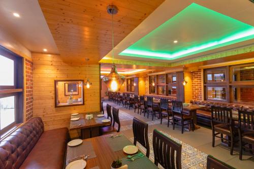 a restaurant with wooden walls and tables and chairs at Sumitel Sanderling 500 meters from Mall Road in Darjeeling