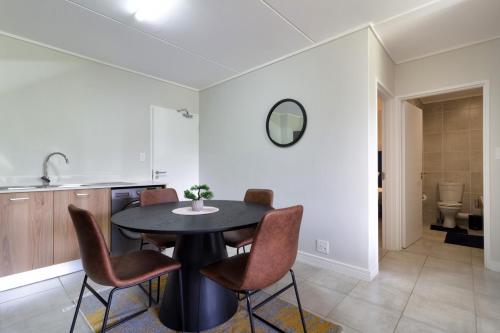 a dining room with a table and chairs at #AlimamaSpaces Jade's Greenlee in Sandton