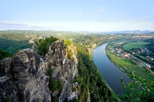 a view of a mountain and a river at Haus Heidi, Wellness und Ayurveda in Kurort Rathen
