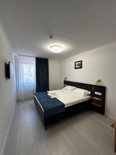 a bedroom with a large bed in a room at Турист in Astana