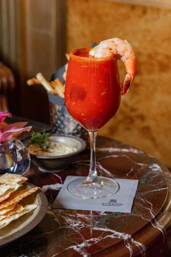 a drink with a shrimp in a glass on a table at The St. Regis Washington, D.C. in Washington