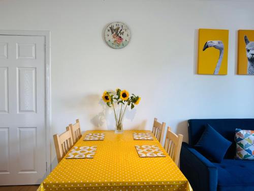 a dining room table with a yellow polka dot table cloth at Lovely Maindoor flat at Murrayfield with Gardens in Edinburgh