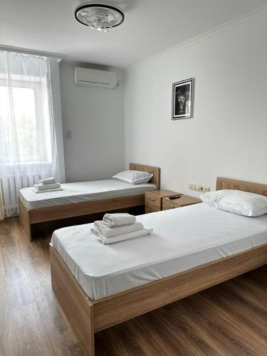 a bedroom with two beds and a window at Турист in Astana