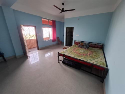 a bedroom with a bed and a ceiling fan at Kamakhya view stay in Guwahati