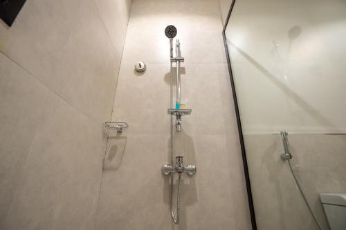 a shower in a bathroom with a glass door at Aljood Residence-BY CH in Al Madinah