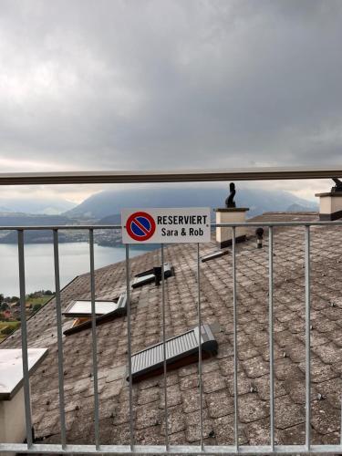 a sign on a fence on top of a mountain at Sweet Retreat W Dreamy Lakeviews in Aeschlen ob Gunten