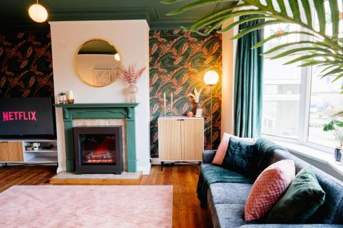 a living room with a couch and a fireplace at Stylish Skipton 3 Bed, WIFI, Dog Friendly, Walks in Skipton