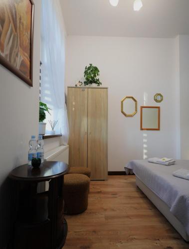 a bedroom with a bed and a table and a cabinet at Stacja Binino 