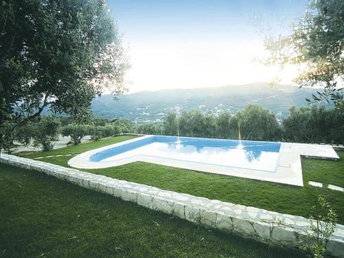 a swimming pool in the middle of a yard at Holiday Residence Rodanthi, Darmarochori in Darmarochori