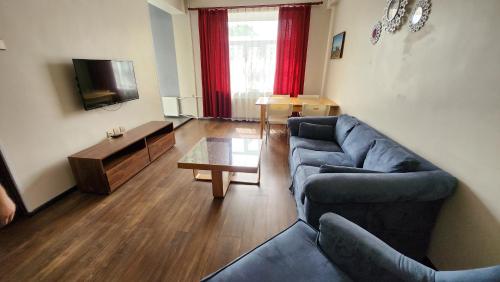 a living room with a couch and a table at Zaya Stays Heart of Ulaanbaatar Main Square in Ulaanbaatar