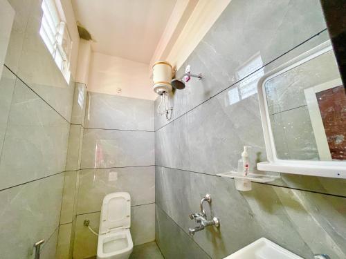a small bathroom with a toilet and a sink at UJJAIN HOTEL TEERUPATI - INN Near Shri Mahakaleshwar Jyotirlinga Temple - Fully Air conditioned Rooms Prime Location - A Superior Hoten In Ujjain in Ujjain
