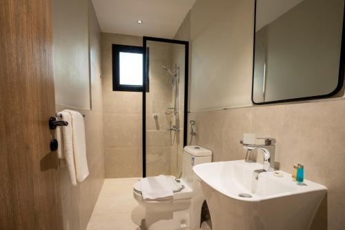 a bathroom with a sink and a toilet and a shower at Aljood Residence-BY CH in Al Madinah