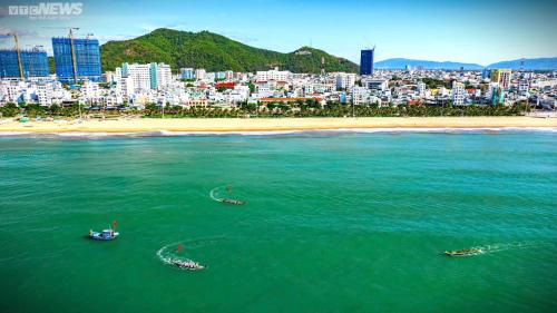 a group of boats in the water near a beach at Khách sạn Đông Tây Quy Nhơn in Quy Nhon