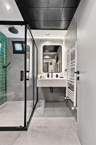 a bathroom with a sink and a mirror at Zeluxe Suite Hotel in Antalya