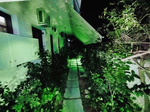 a walkway next to a building with a green roof at Akrata Golden Beach House 2 in Aíyira