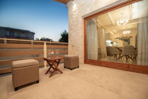 a balcony with a table and a dining room at Aurum Luxury Villa Voz by elite" in Laganas