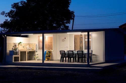 a house with chairs and a table in it at Family House GO TO - Parking & Dog Yard in Kavarna