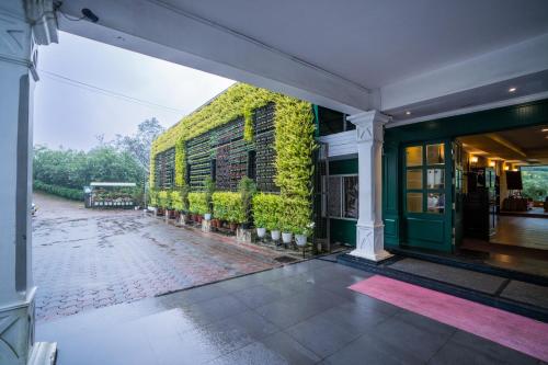 an exterior view of a building with plants on it at Hotel C7 Munnar in Munnar
