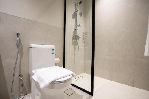 a bathroom with a shower and a toilet at Aljood Residence-BY CH in Al Madinah