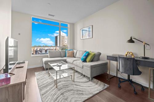 a living room with a couch and a table at luminous 2-Bedroom Apartment with Balcony in Toronto