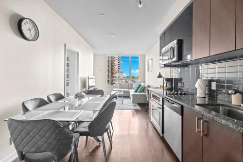 a kitchen with a table and chairs in a room at luminous 2-Bedroom Apartment with Balcony in Toronto
