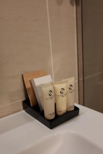 three rolls of toilet paper sitting on a shelf at Hotel La Falaise Bonapriso in Douala